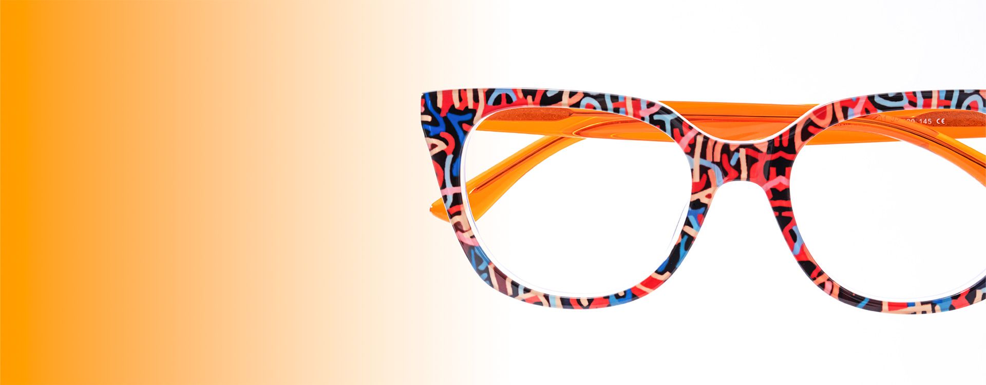 Maximalism style glasses featuring bold, colorful patterns and vibrant orange arms, perfect for a statement look.