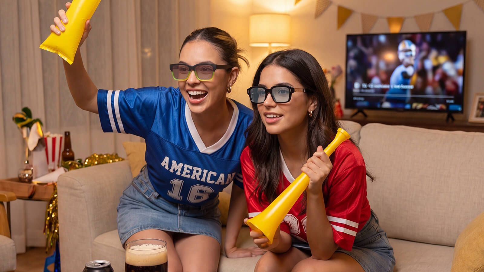 fifa fans watching games at home with sporty outfits and sunglasses
