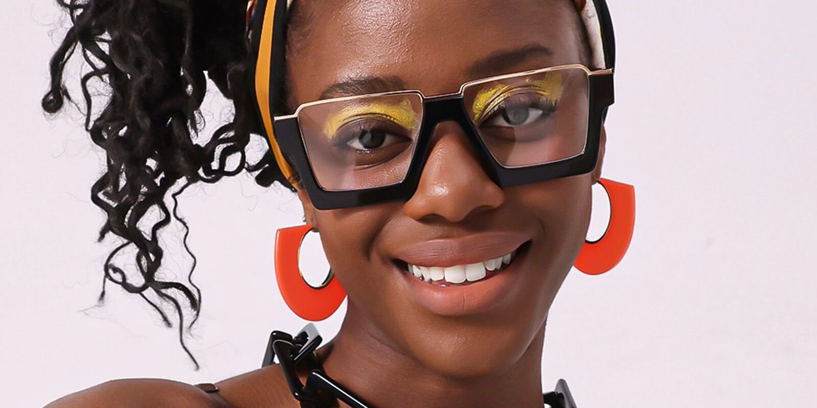 Curly-haired woman wearing pan-Afro style glasses