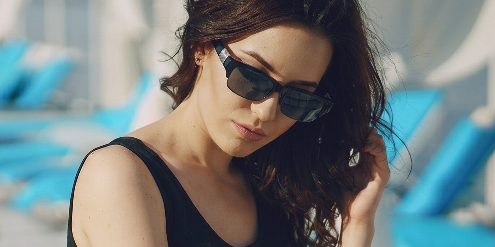 a woman wearing semi-rimless sunglasses