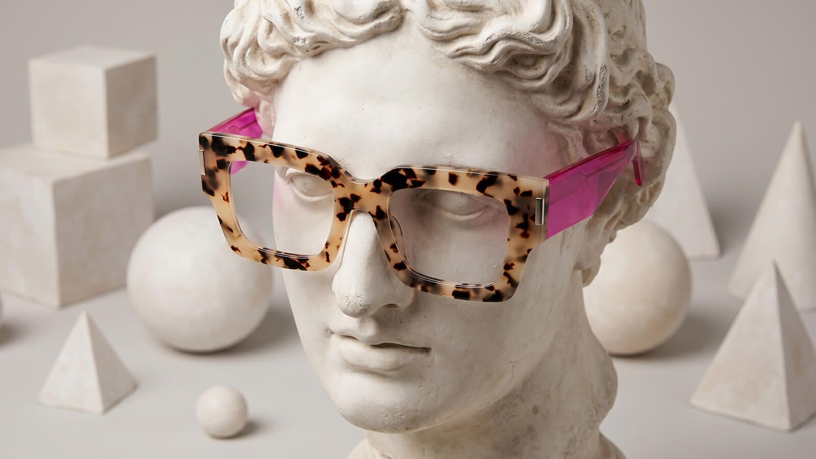 A white plaster bust wearing artistic Vooglam glasses.