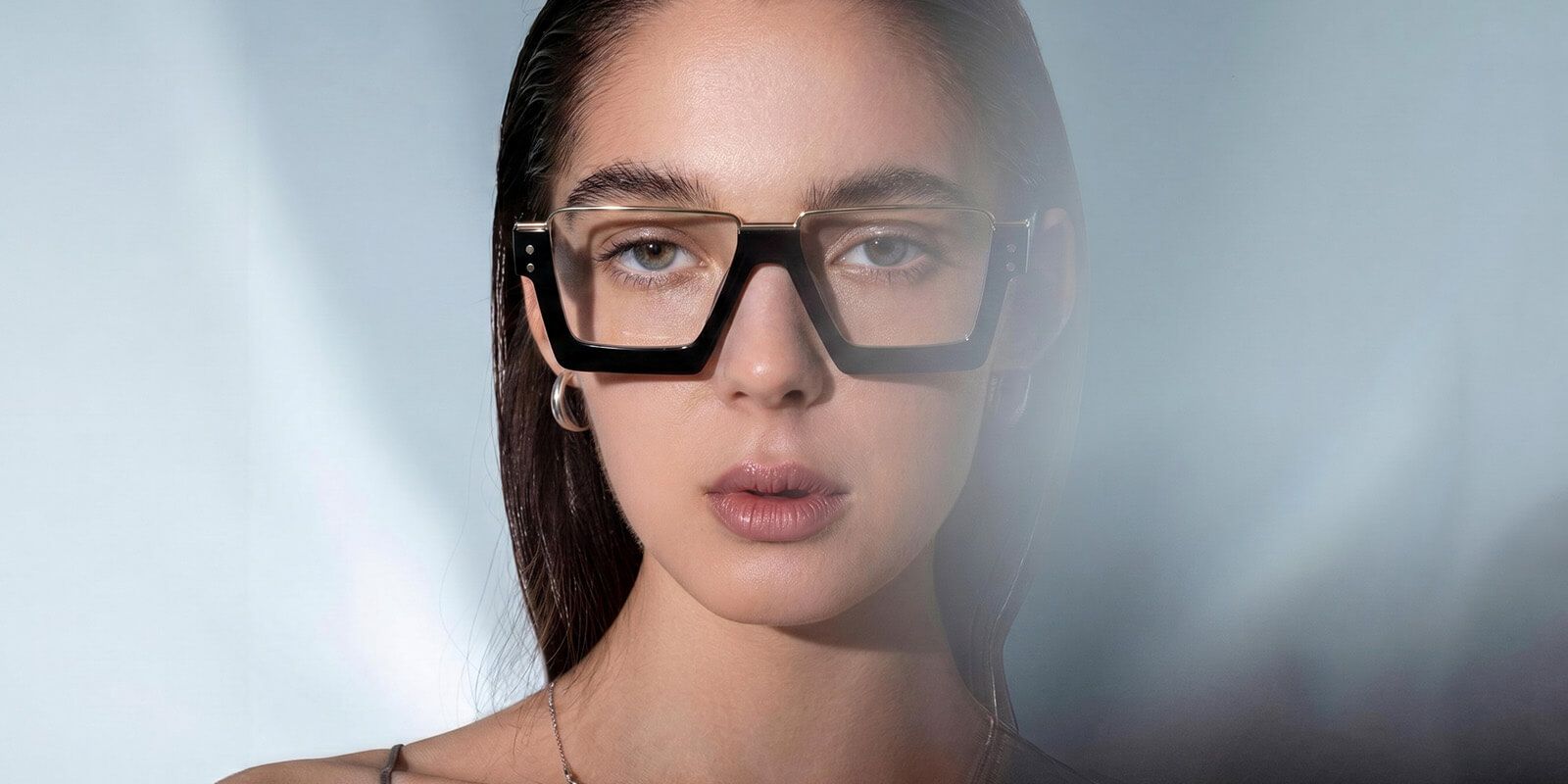 a round face woman wearing brownline glasses