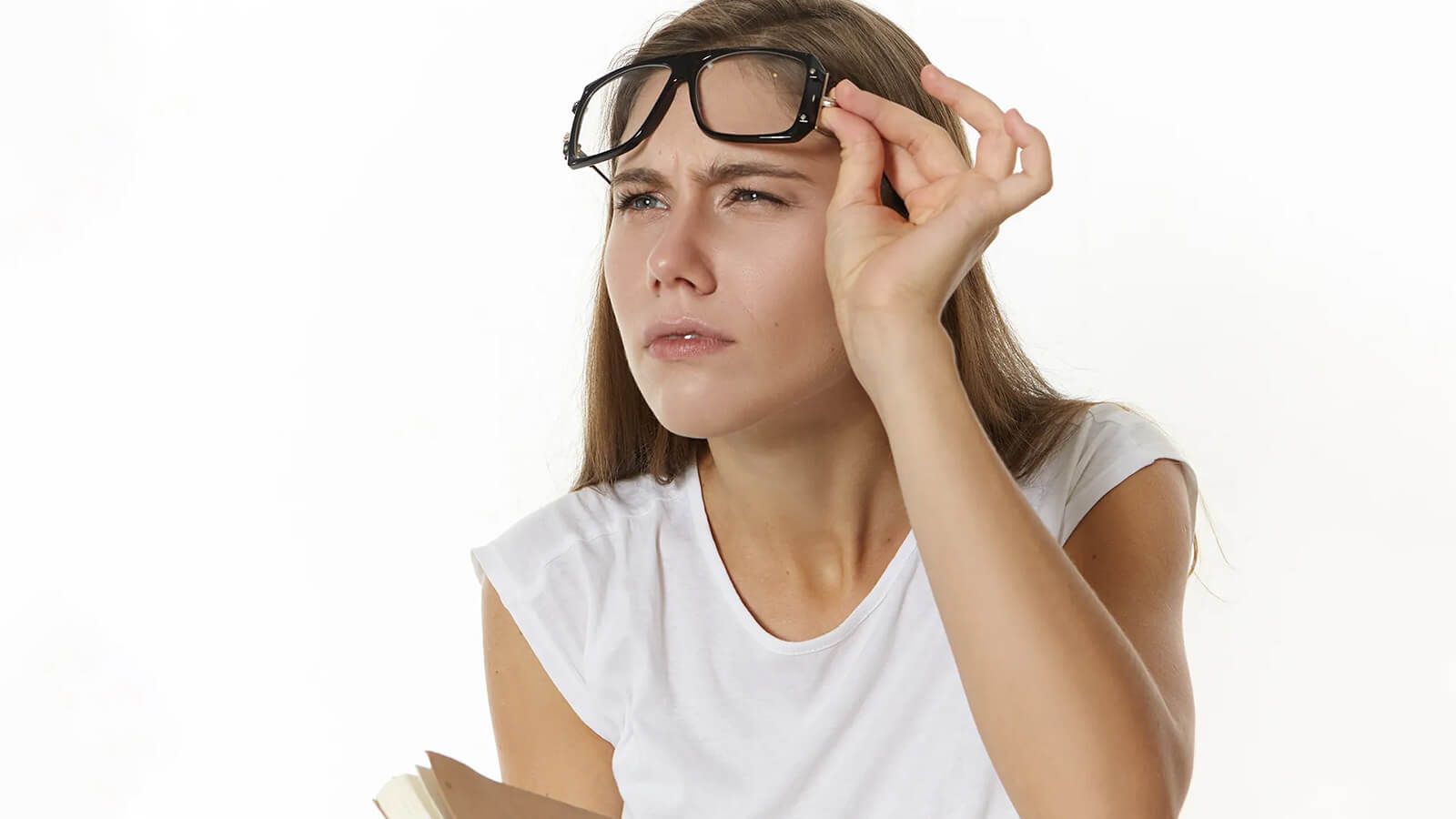 A woman with impaired vision has difficulty seeing things clearly after taking off her glasses