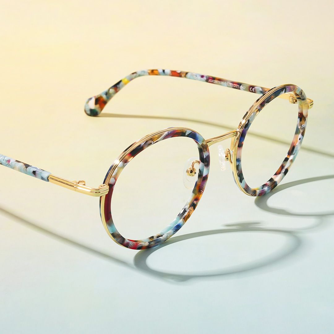 Unique round glasses with a vibrant, multicolored frame and gold accents.