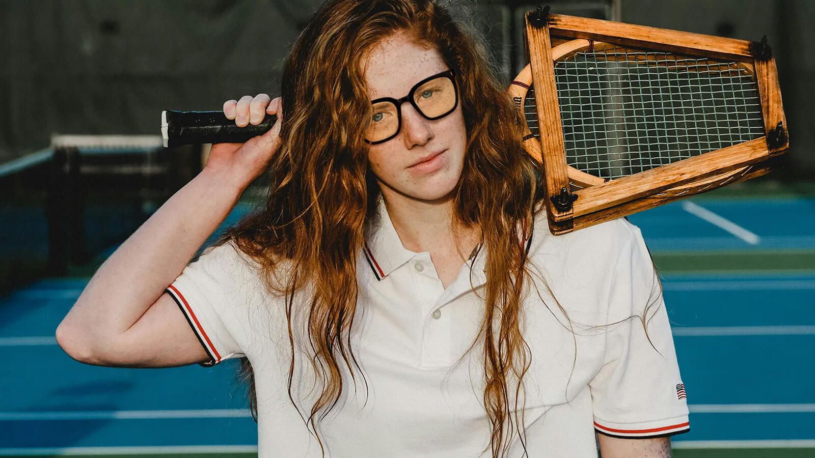 Long-haired girl holding a tennis racket