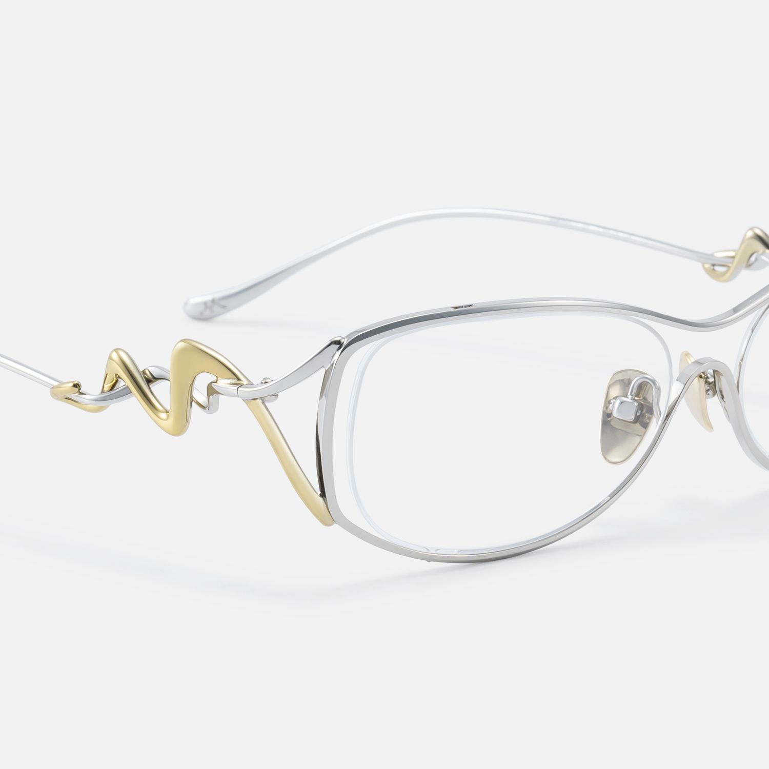 This artist collab merges silver metal glasses with gold deco, double wire temple glasses and hollow glasses frames.