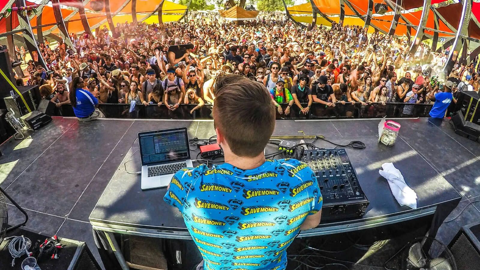 The MC of the electronic music festival is interacting with the audience on stage