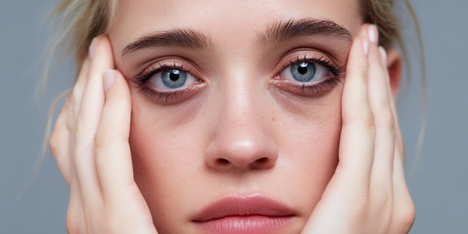 The woman looks a little haggard because of the bags under her eyes
