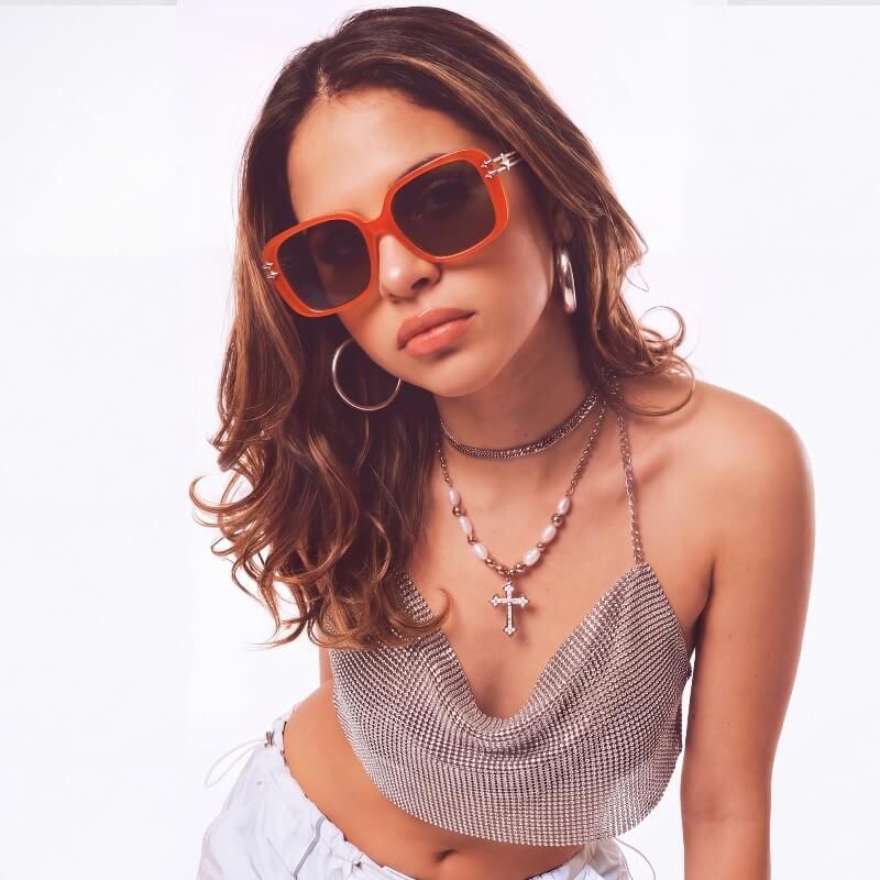 night time y2k outfits with neon orange glasses with y2k star design on the side
