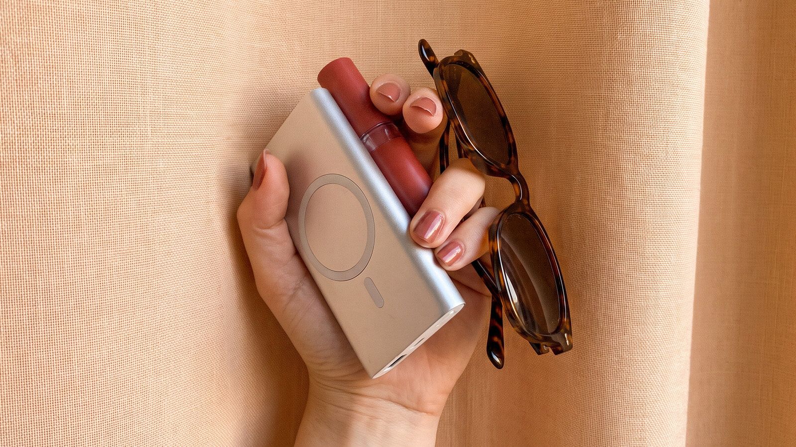 magnetc wireless power bank, lip cream and a tortoise polarized sunglasses for driving